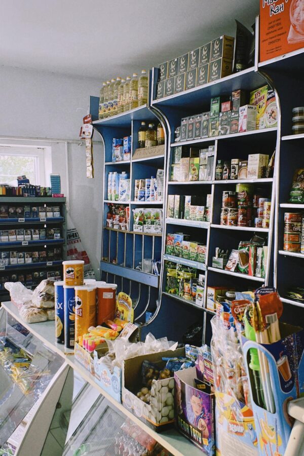 Packed shelves in a Shymkent grocery store with various products on display.
